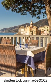 Table Set In Italian Restaurant In Front Of Camogli Bay, Near Genoa