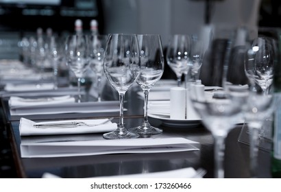 Table set for official dinner, focus on glasses