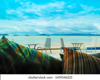 A Table Set Up For  A Romantic Meal On The Beach  And Sky And Sea In The Background