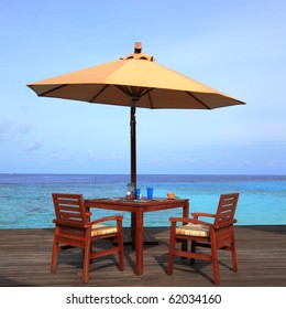 Table Set And Umbrella On The Deck