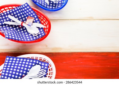 Table Set With White, Blue And Red Decorations For July 4th Barbecue.