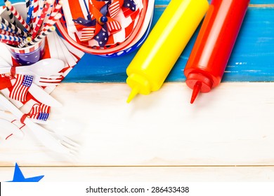 Table Set With White, Blue And Red Decorations For July 4th Barbecue.