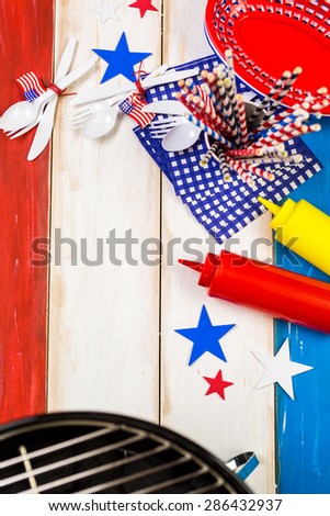 Table set with white, blue and red decorations for July 4th barbecue.