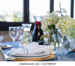 Table Setting At A Baptismal Religious Event With Wine And Water In The Background