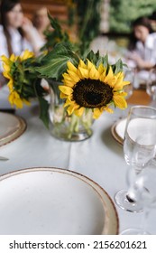 Table Setting, Beautiful White Plates, Silver Cutlery And Crystal Glasses. Outdoor Feast On Holiday. Decor From Sunflower On Party