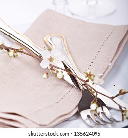 Table setting with blossoming spring flowers
