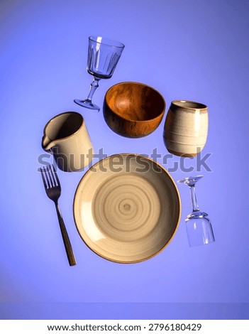 A table setting with ceramic dishes and glassware