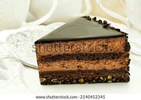 Table setting with Chocolate Cream Cake and coffee cups closeup