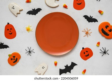 Table Setting With Cute Halloween Decor On White Background