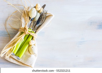 Table Setting For Easter Dinner With Eggs On White Wooden Table