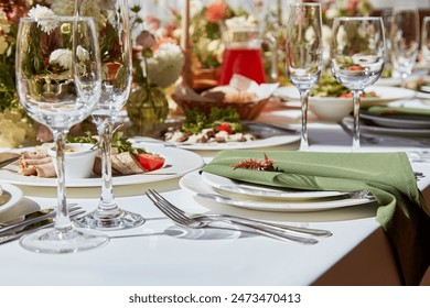 Table setting in elegant chamber is graced by candles and flowers arrangement casting sunlight shadows. The wedding embodies the aesthetics of Provence.