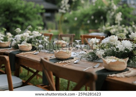 Table setting with flower arrangement for private party outdoors