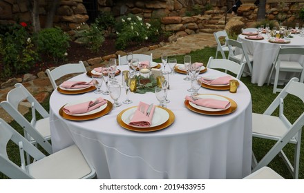 Table setting for garden wedding reception. Event rental equipment concept.