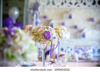 Table Setting At A Luxury Wedding Reception. Example Of Festive Decorating. Real Flowers On Table For Bride And Groom.