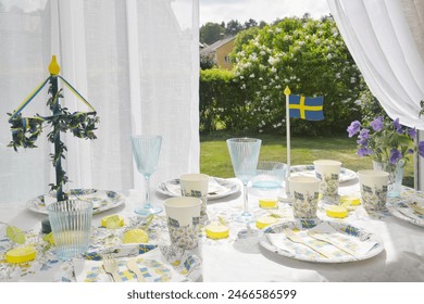 Table setting for the Midsommar holiday, with themed disposable tableware. - Powered by Shutterstock