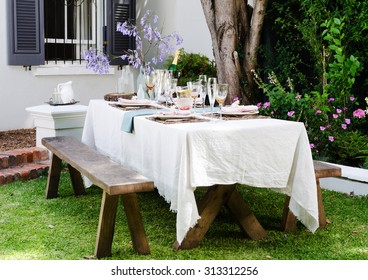 Table Setting For An Outdoor Garden Party With Neutral Nude Color Scheme