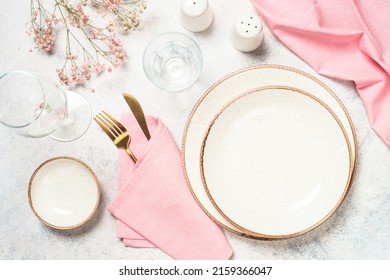 Table setting with plate, flowers and cutlery at white kitchen table. Spring or summer table setting. Top view with copy space. - Powered by Shutterstock