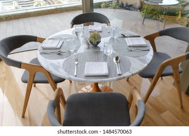 Table setting in the restaurant. Decorated elegant table, glasses, napkin, knife, fork and spoon