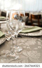 table setting in restaurant, elegant table setting with wine glasses, luxurious banquet table decor, fine dining setup with silverware, sophisticated dinner table with glasses
