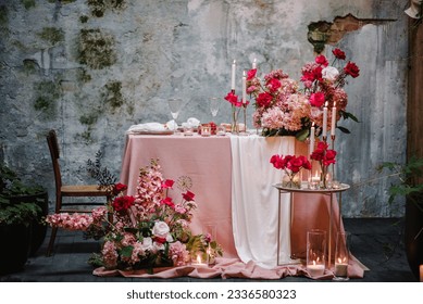 Table setting in restaurant. Location for surprise marriage proposal. Engagement. Decoration flowers, decor candles. Luxury romantic date. Candle light dinner setup table for couple on Valentines day.