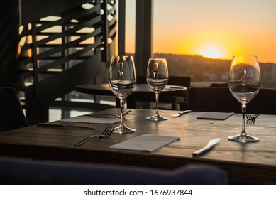 Table Setting in Restaurant with Sunset