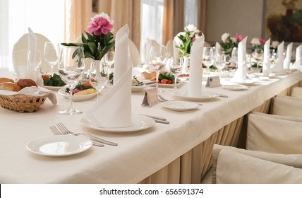 Table Setting, Selective Focus. Table Served For Wedding Banquet, Close Up View. White Napkin On White Empty Plate On Dinner Table