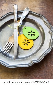 Table setting with vintage plate and silverware for Easter celebration
