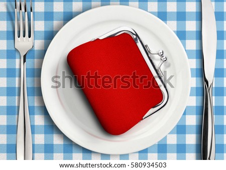 Table setting with wallet on plate, finance concept