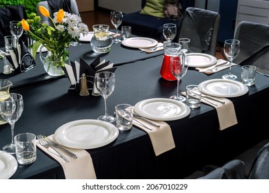 Table setting for a wedding or dinner event, black tablecloth white plates-2. - Powered by Shutterstock
