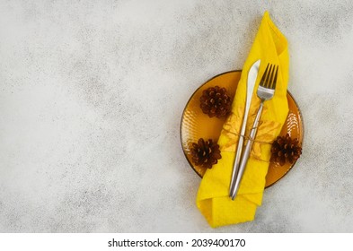 Table Setting With Yellow Ceramic Plate And Napkin, Festive Food Concept And Autumn Dinner Preparation