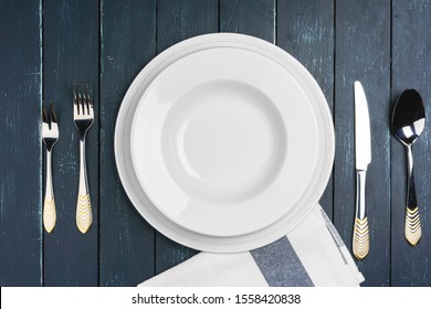 Table Setup With Plates On Dark Wooden Background