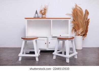 table shelf for storing goods and can be used to sweeten the room in white paint with a brown top complete with two chairs