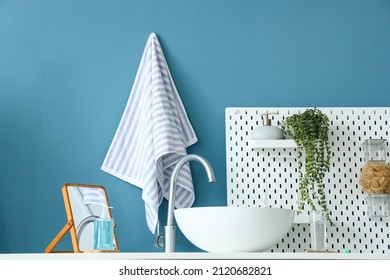 Table With Sink, Mirror And Pegboard Near Blue Wall