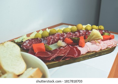 A Table Of Sliced Meats For Dinner On A Friday Night