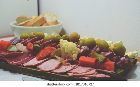 A Table Of Sliced Meats For Dinner On A Friday Night