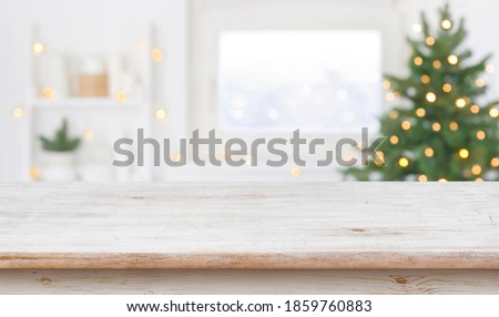 Table space in front of defocused window sill with christmas tree