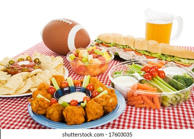 Table Spread With Appetizer Trays For The Footbal Party.  Horizontal View Over White Background.