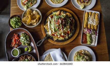 Table Spread Of Family Style Mexican Food Dishes At A Restaurant