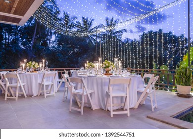Table Spread No People Tropical Location With Gold Cutlery White Table Cloth And Scenic View Romantic Wedding Table Top Layout Copy Space Tablescape Soft Lighting Blue Hour