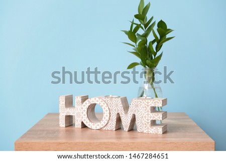Table with stylish decor on color background