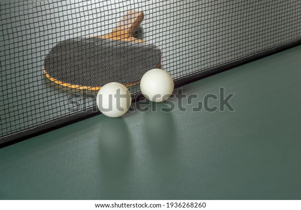 Table\
tennis attributes: Racket, balls, table with a\
net.