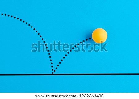 Table tennis ball is bouncing on blue background. [[stock_photo]] © 