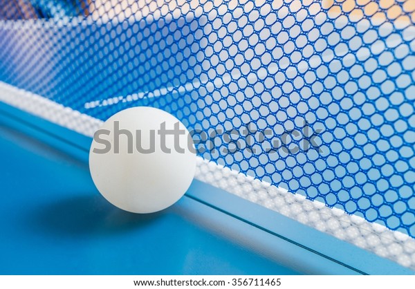 Table tennis ball and net for playing ping pong.\
Sport concept.