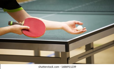 table tennis player doing a serve, close-up