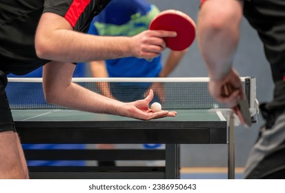 Table tennis player serving in a table tennis championship match - Powered by Shutterstock