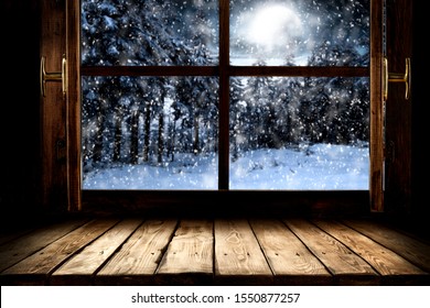 Table top board with big window background and beautiful snowy winter landscape outside. Moonlight winter night.