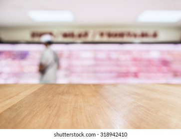 Table Top Counter With Blurred Fresh Food Meat Display In Supermarket