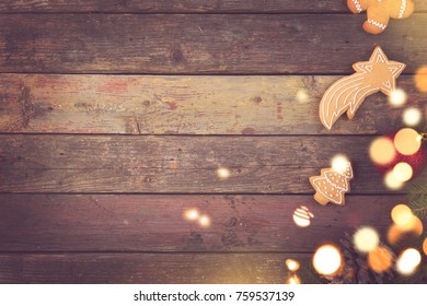 Table Top Shot Of Come Fir Branches Decorated With Gingerbread Cookes And Christmas Lights 