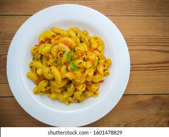 Table Top Shot Of Delicious Macaroni Pasta Served In A White Plate On Wooden Table. 