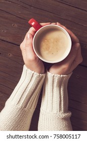 Table Top Shot Of Female Hands Holding A Cup Of Hot Coffee